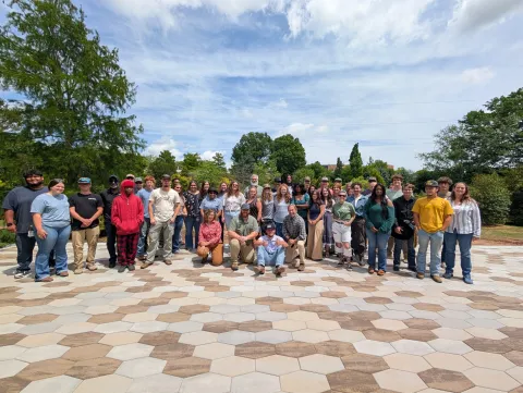 Group of students posing for picture on a pavilion