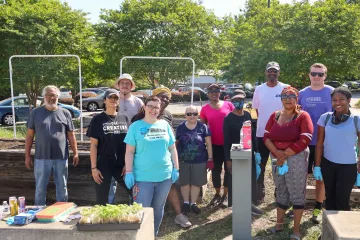 Group of people in front of a garden