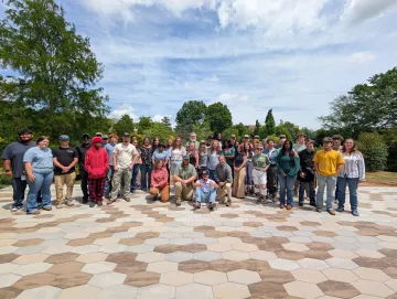 Group of students posing for picture on a pavilion
